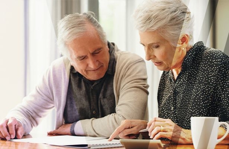 An older couple looking at documents